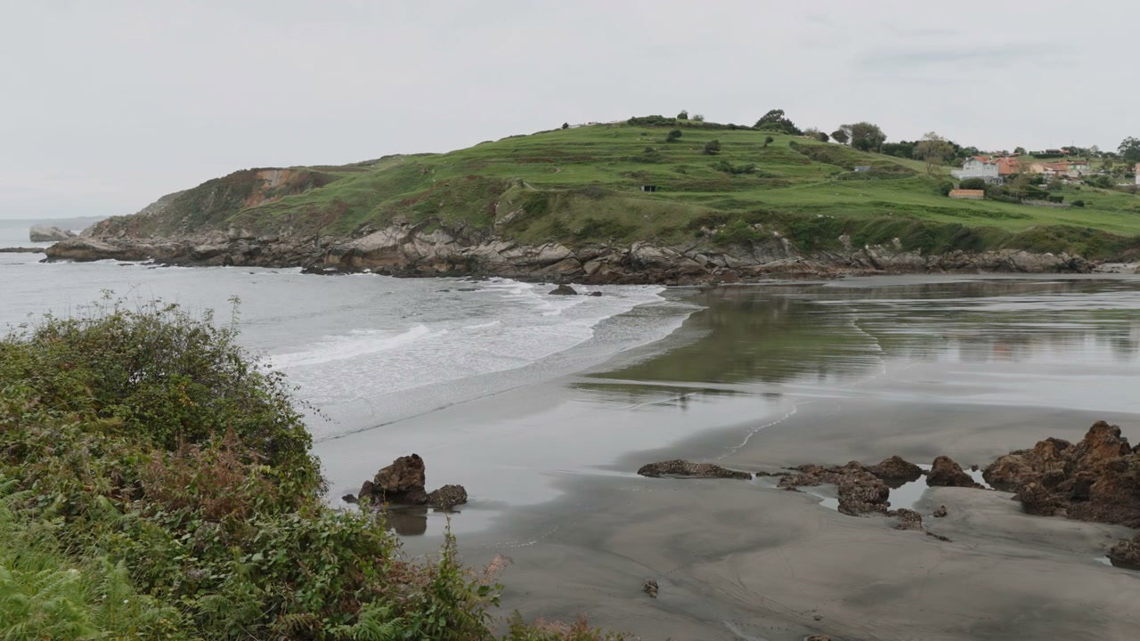 Scenic Bay with Rolling Waves and Green Hills