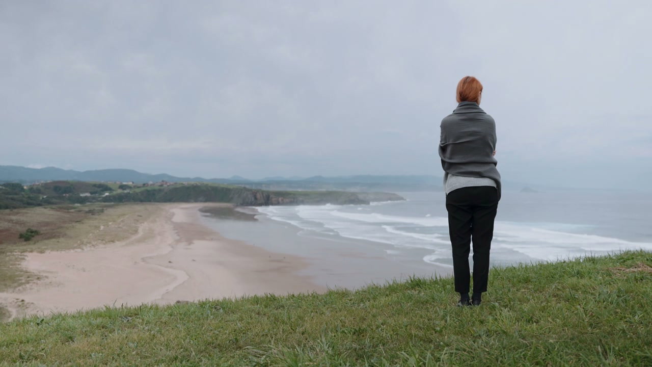 Woman Overlooking Coastal Beach
