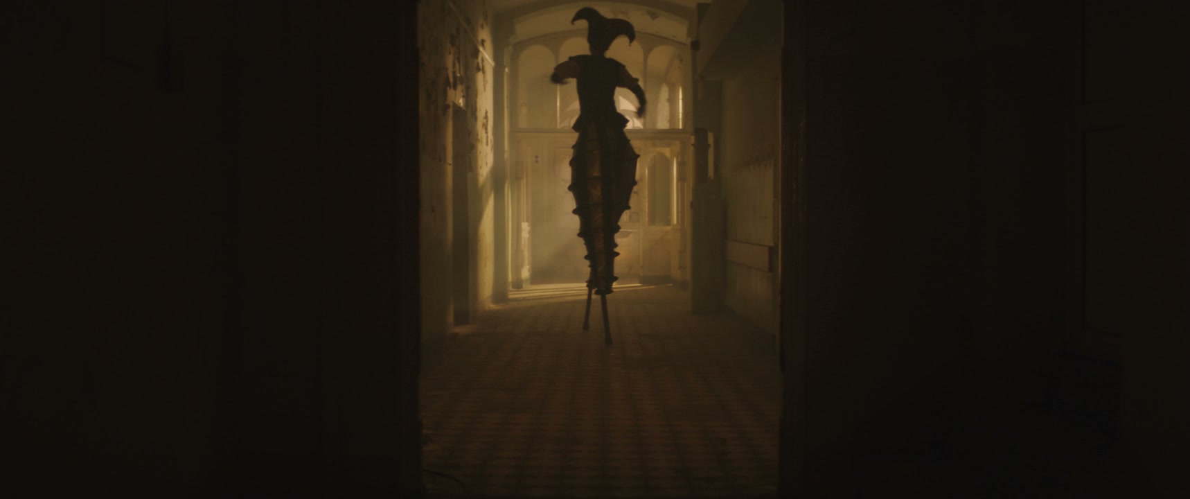 Creepy Jester Figure Dancing in Hallway