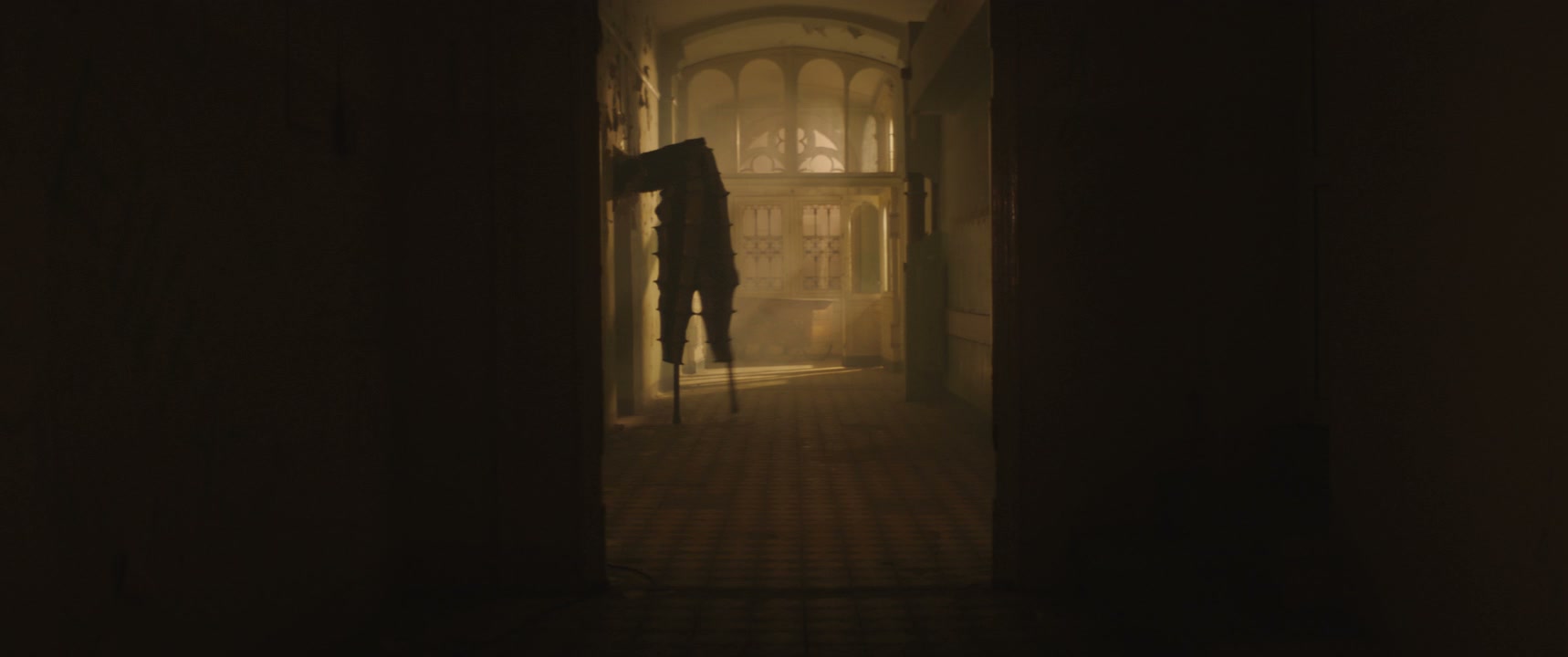 Shadowy Figure on Stilts in Dark Hospital Hall