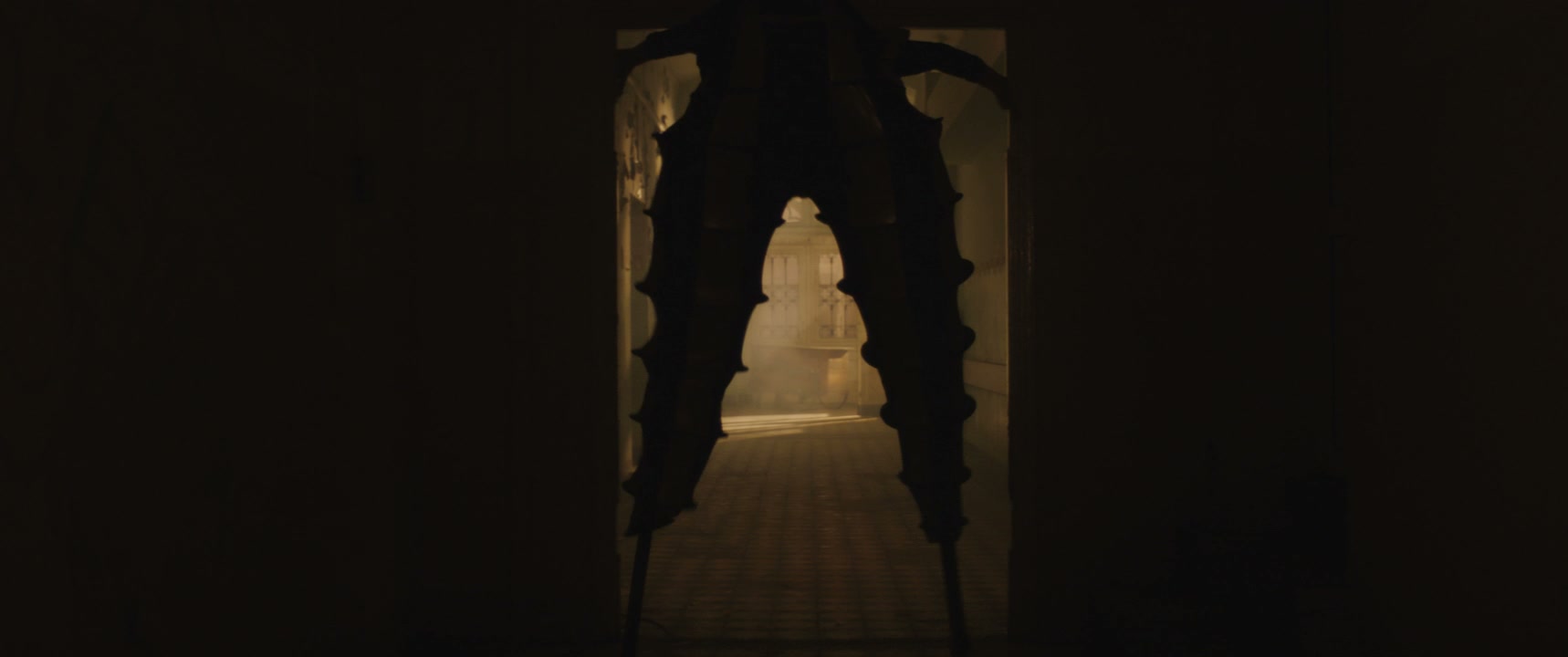 Jester on Stilts Performing in Dark Hallway
