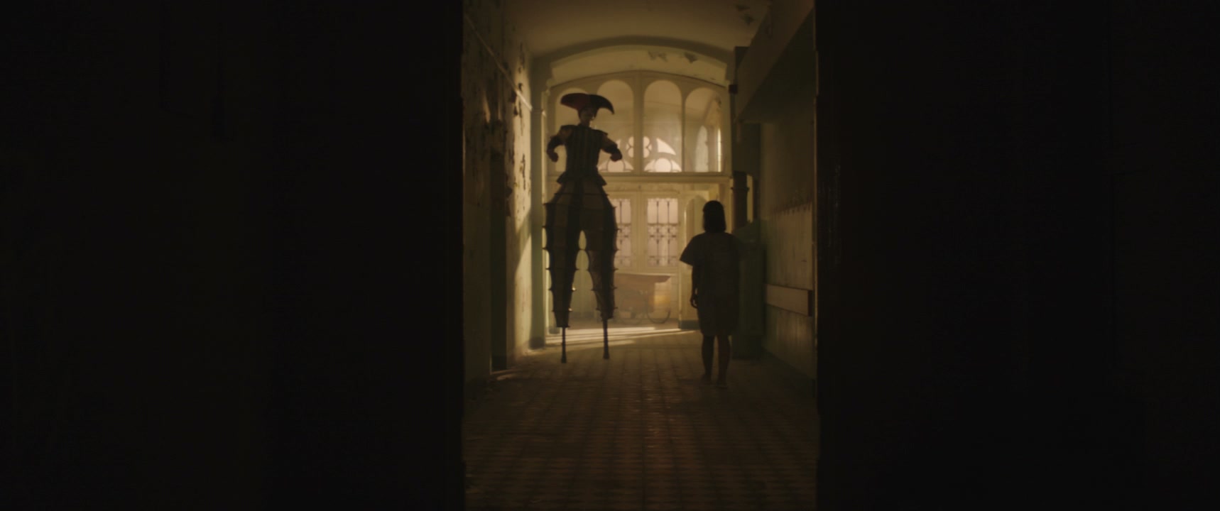 Creepy Jester And Person In Hospital Hall