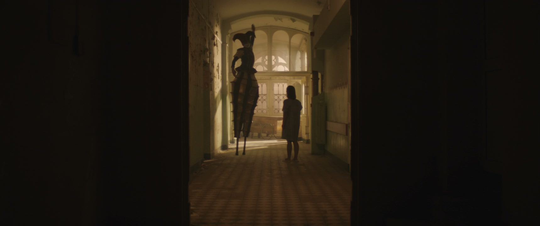 Eerie Jester on Stilts and Person in Hospital