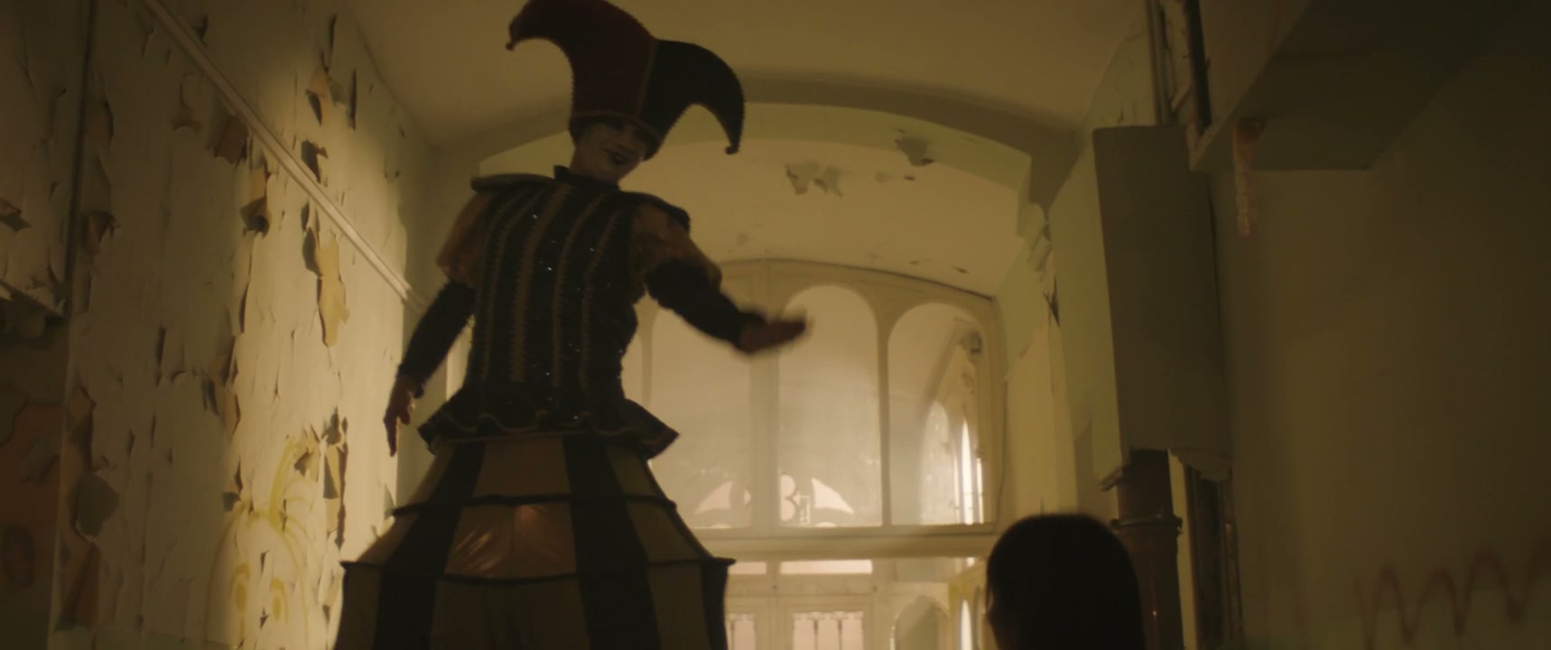 Jester on Stilts and Patient in Hospital Hallway