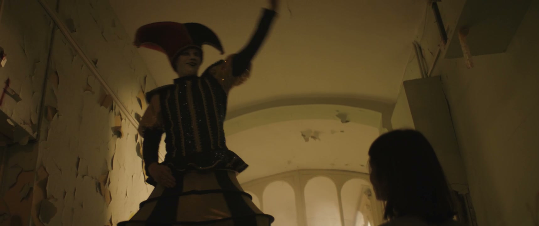 Creepy Jester Leading Person in Derelict Hospital
