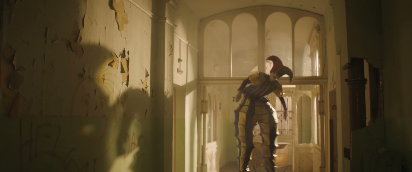 Creepy Jester on Stilts in Abandoned Hallway