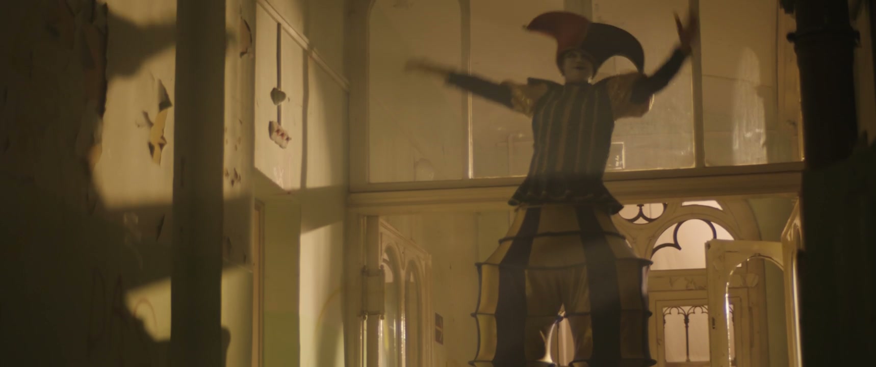 Creepy Jester on Stilts in Eerie Hallway