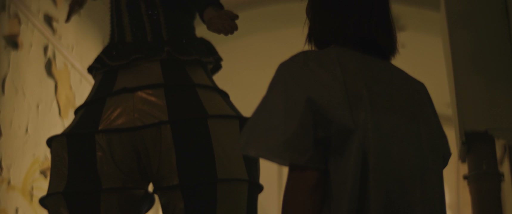 Jester Leading Person Through Abandoned Hallway