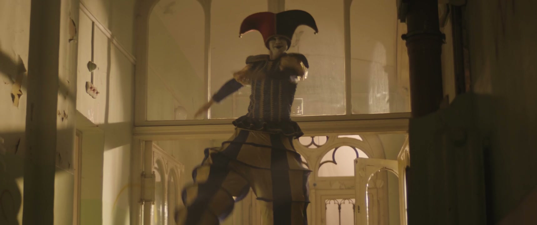 Creepy Jester on Stilts Appears in Old Building