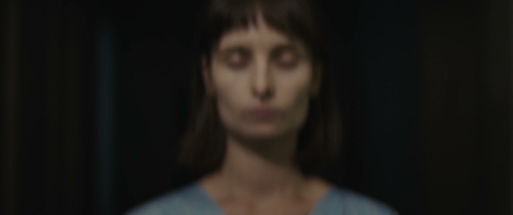 Woman Patient Opening Eyes in Dark Room
