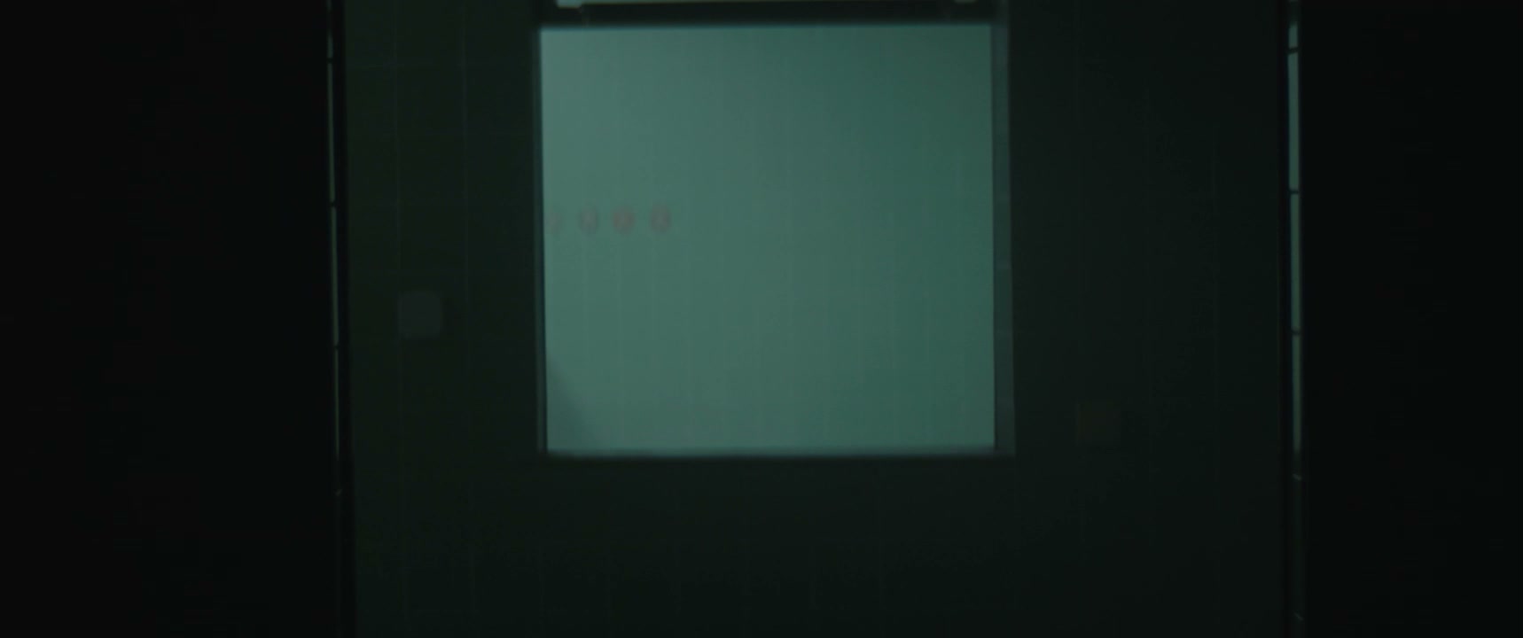 Shadowy Figure Passes Glowing Screen