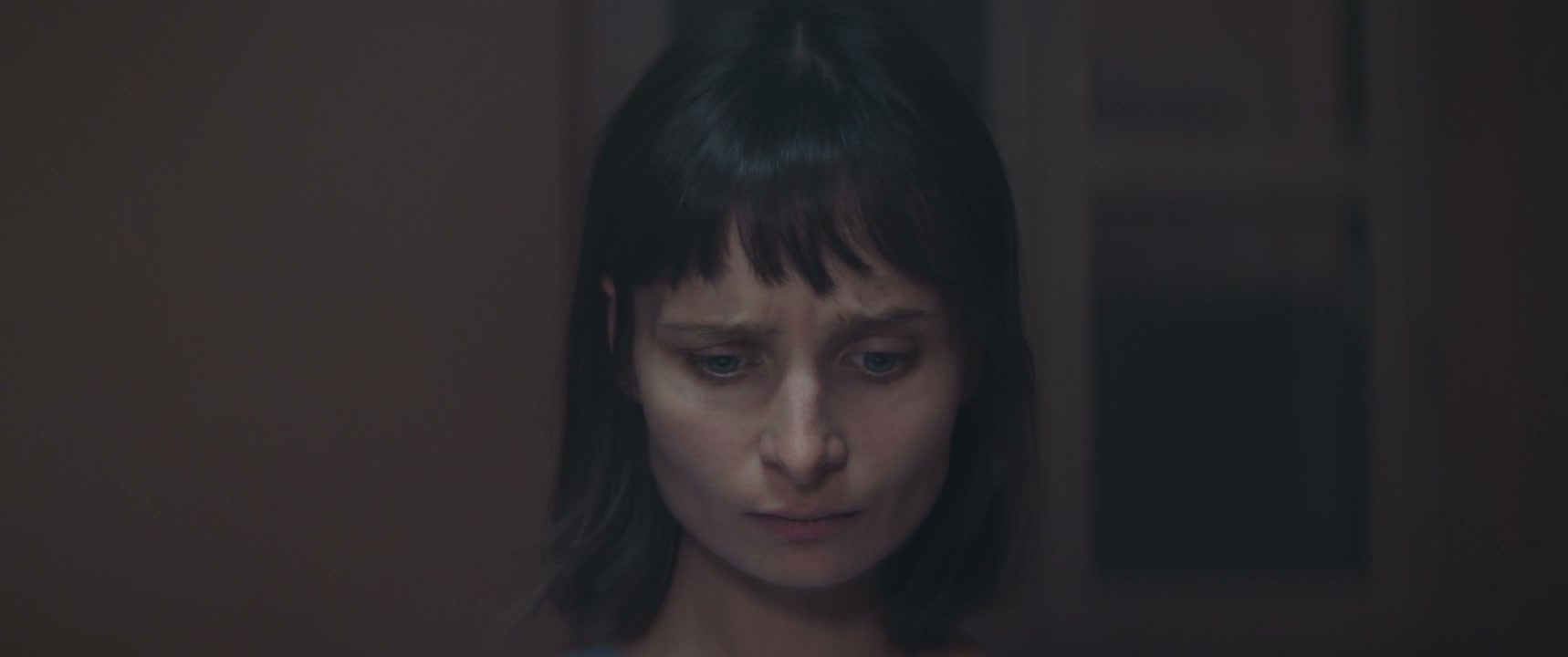 Worried Woman in Hospital Room