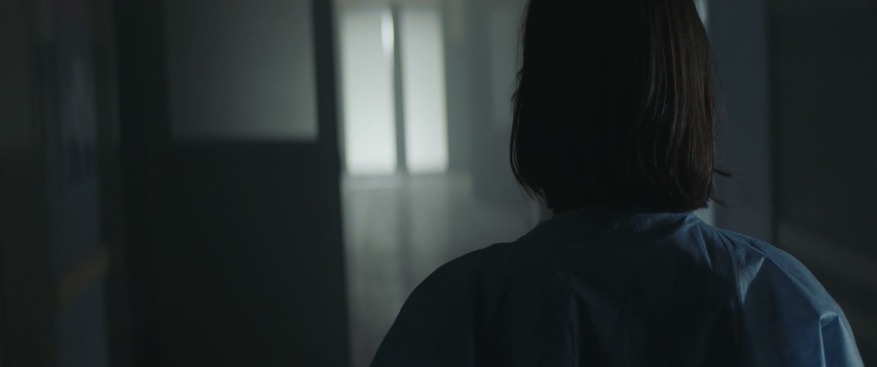 Person Running in Dark Hospital Hallway