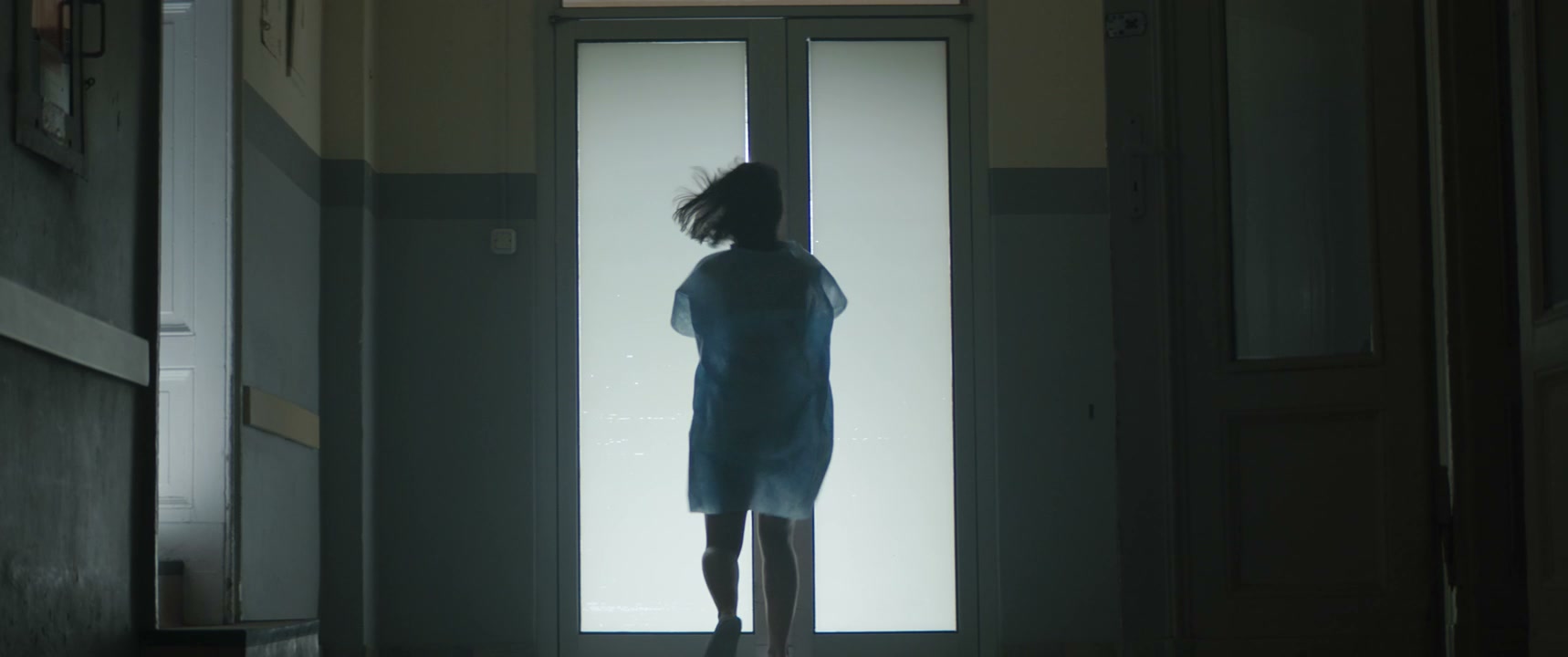 Person Running Through Hospital Corridor