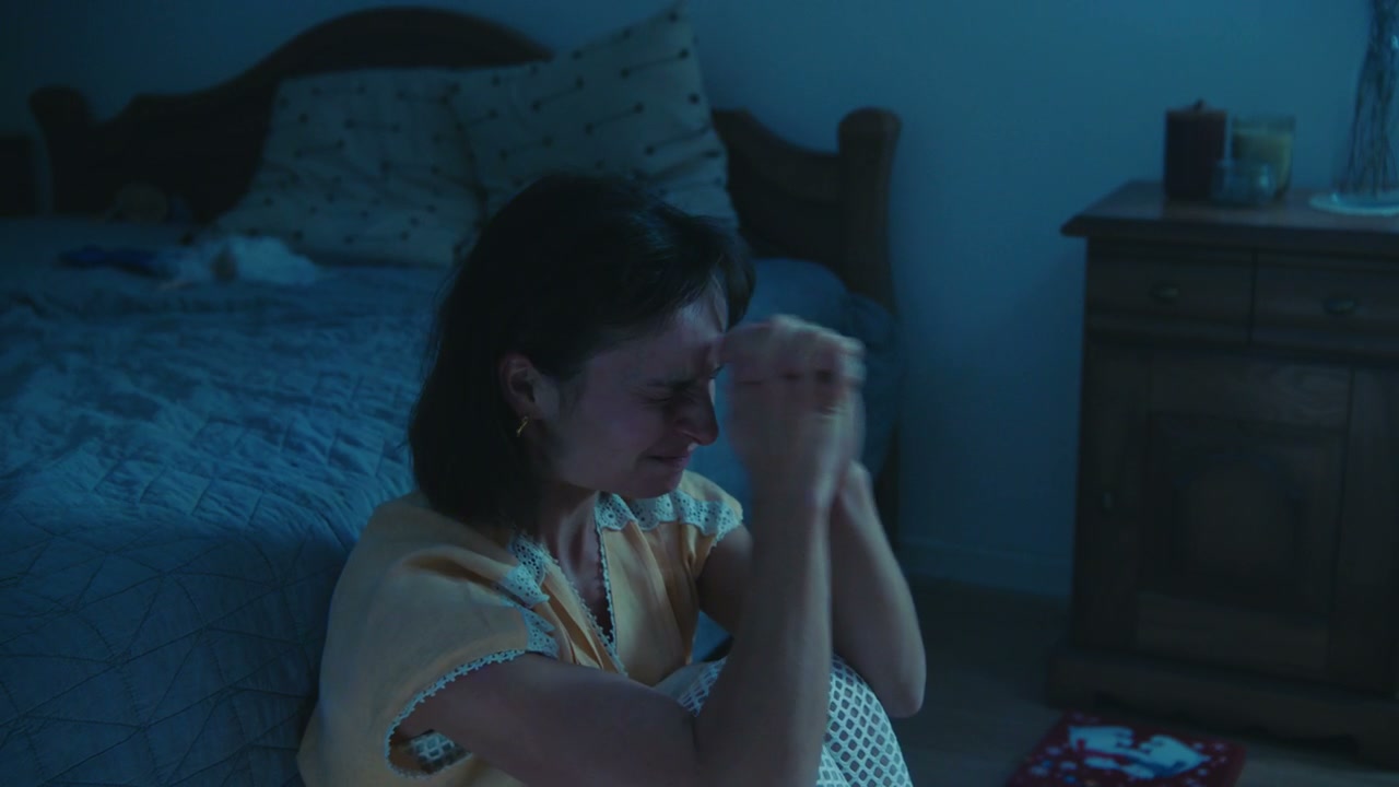 Distressed Woman Crying in Bedroom at Night