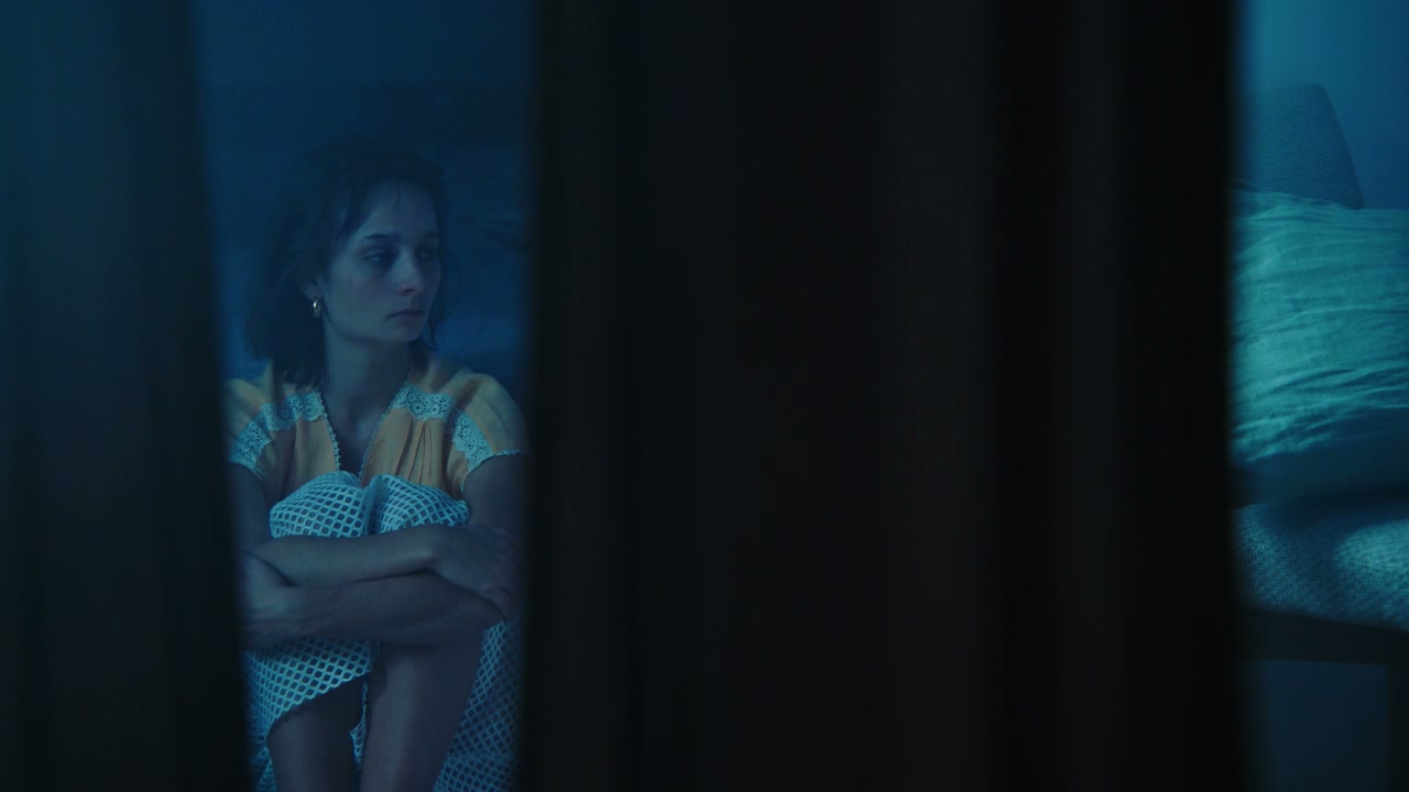 Distressed Woman Sitting Alone in Dark Room
