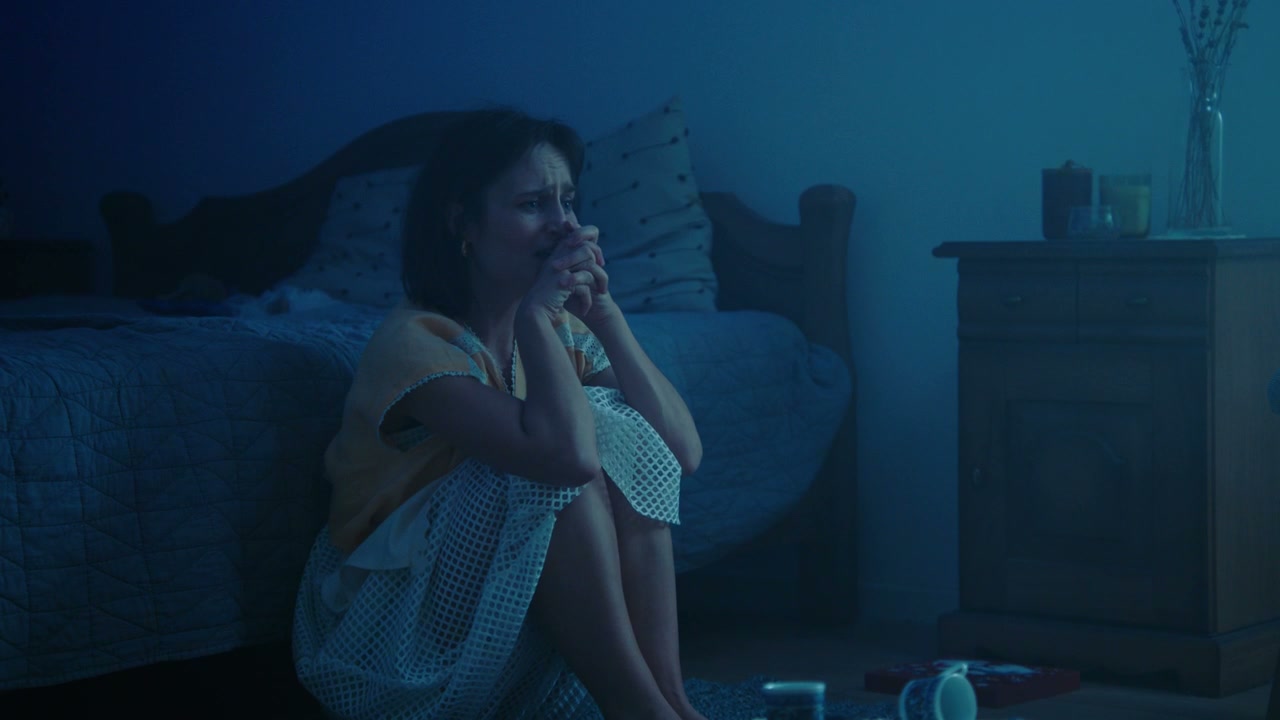 Distressed Woman Crying in Bedroom
