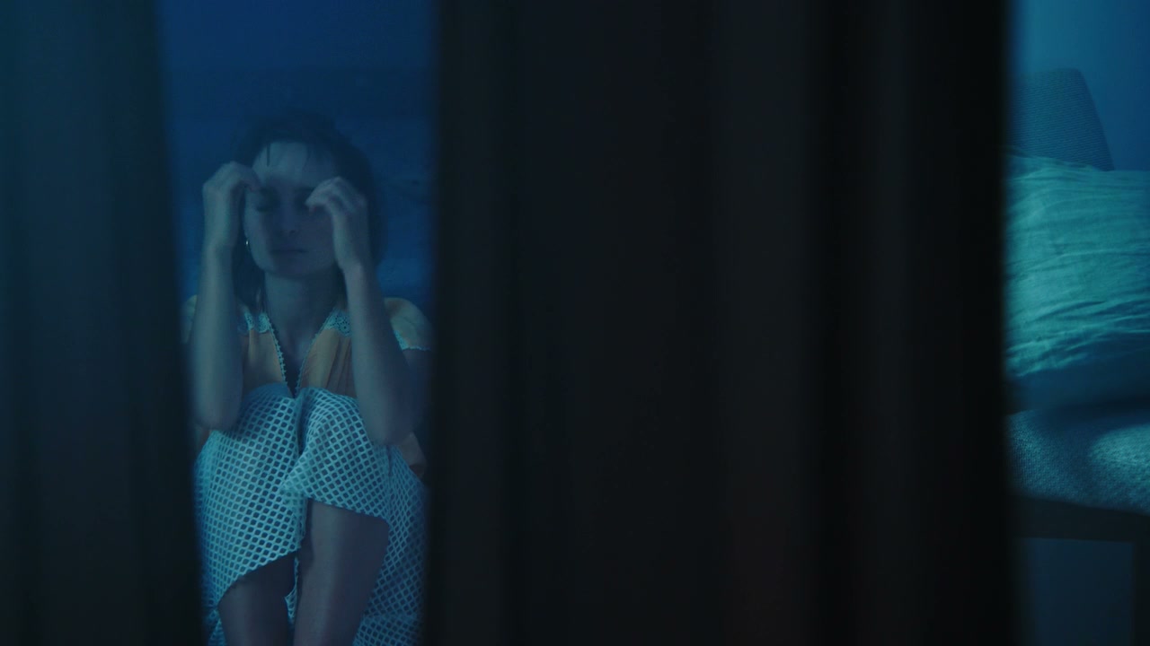 Upset Woman Hiding Face in Dark Room