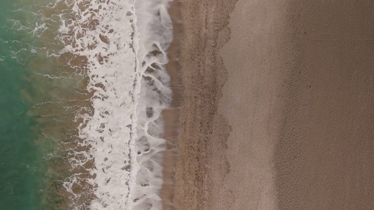 Aerial View of Waves Breaking on New Zealand Beach