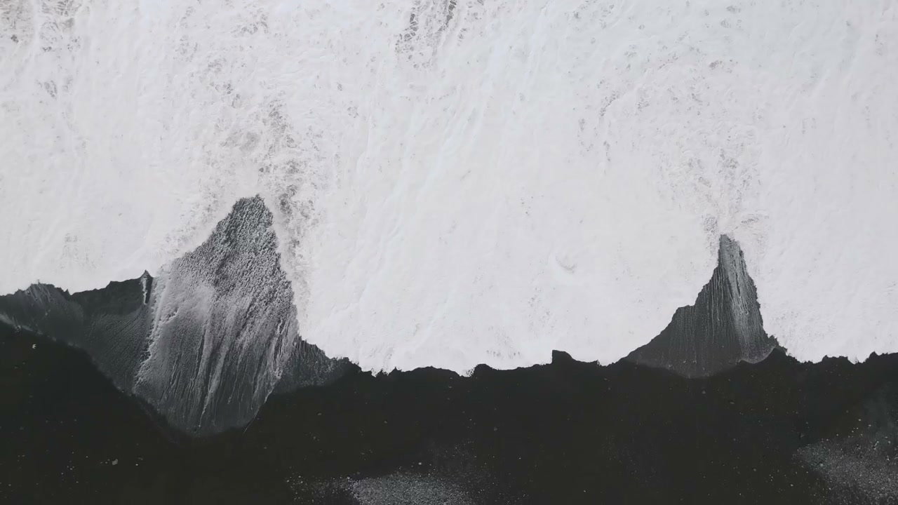 Waves Crashing on Black Sand Beach in New Zealand