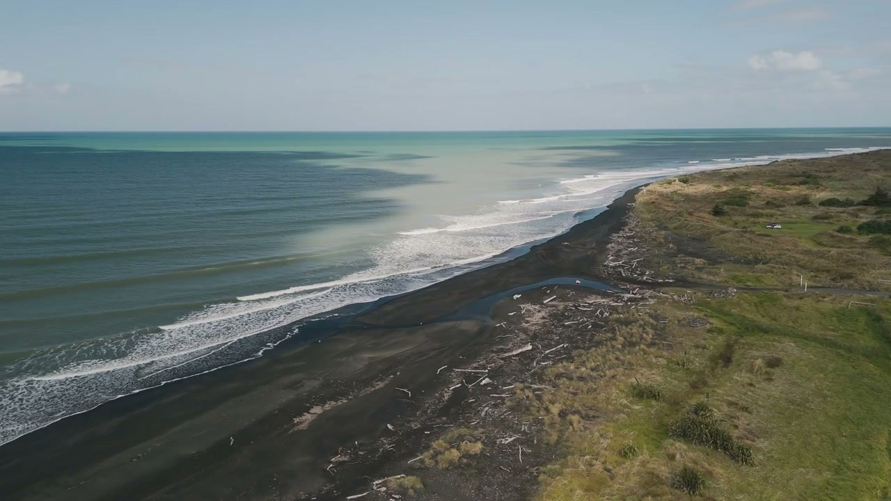 New Zealand Black Sand Beach and Ocean Waters
