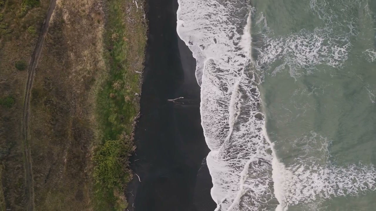 Waves Crashing on New Zealand Black Sand Beach