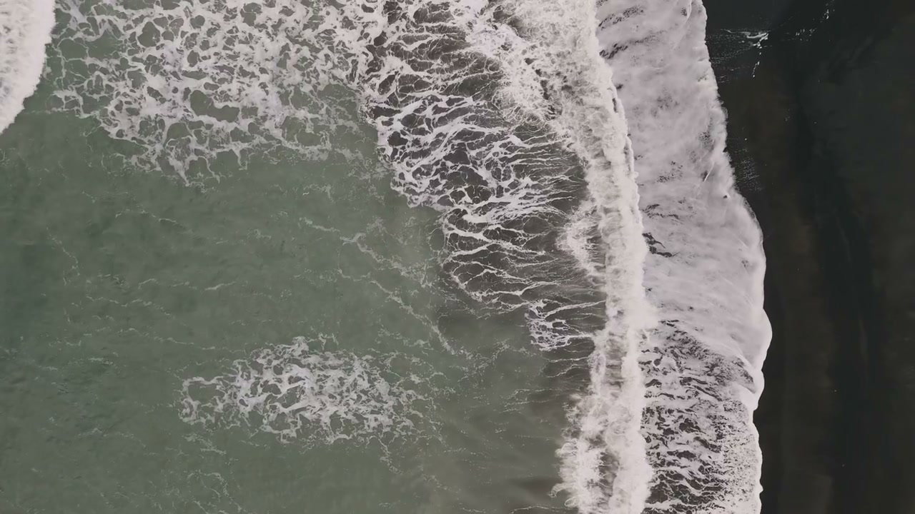 Aerial Ocean Waves on Dark Sand Beach, New Zealand