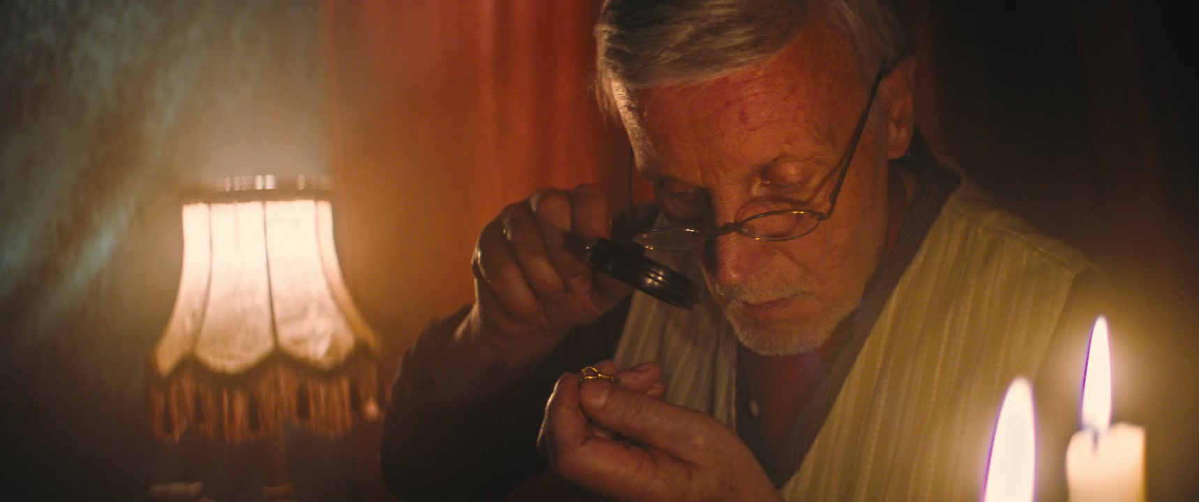 Retro Senior Man Inspects Gold Jewelry
