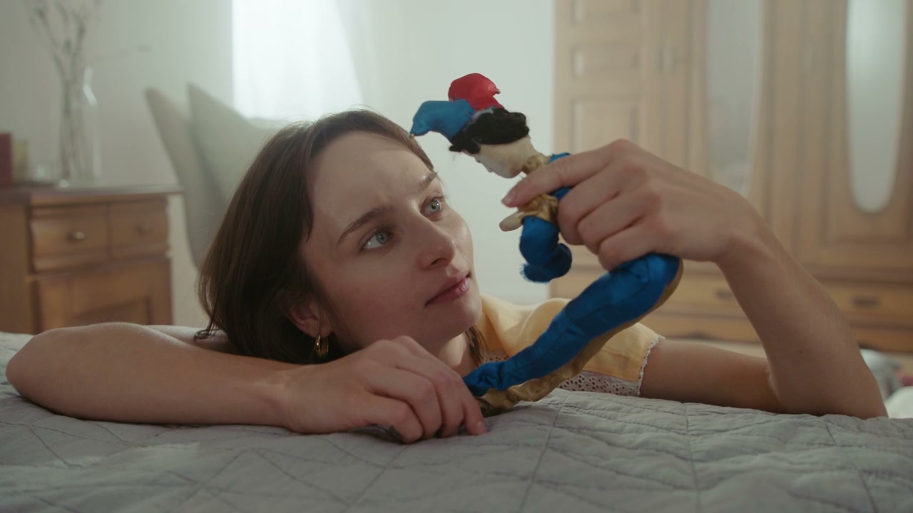 Young Woman Plays with Jester Doll