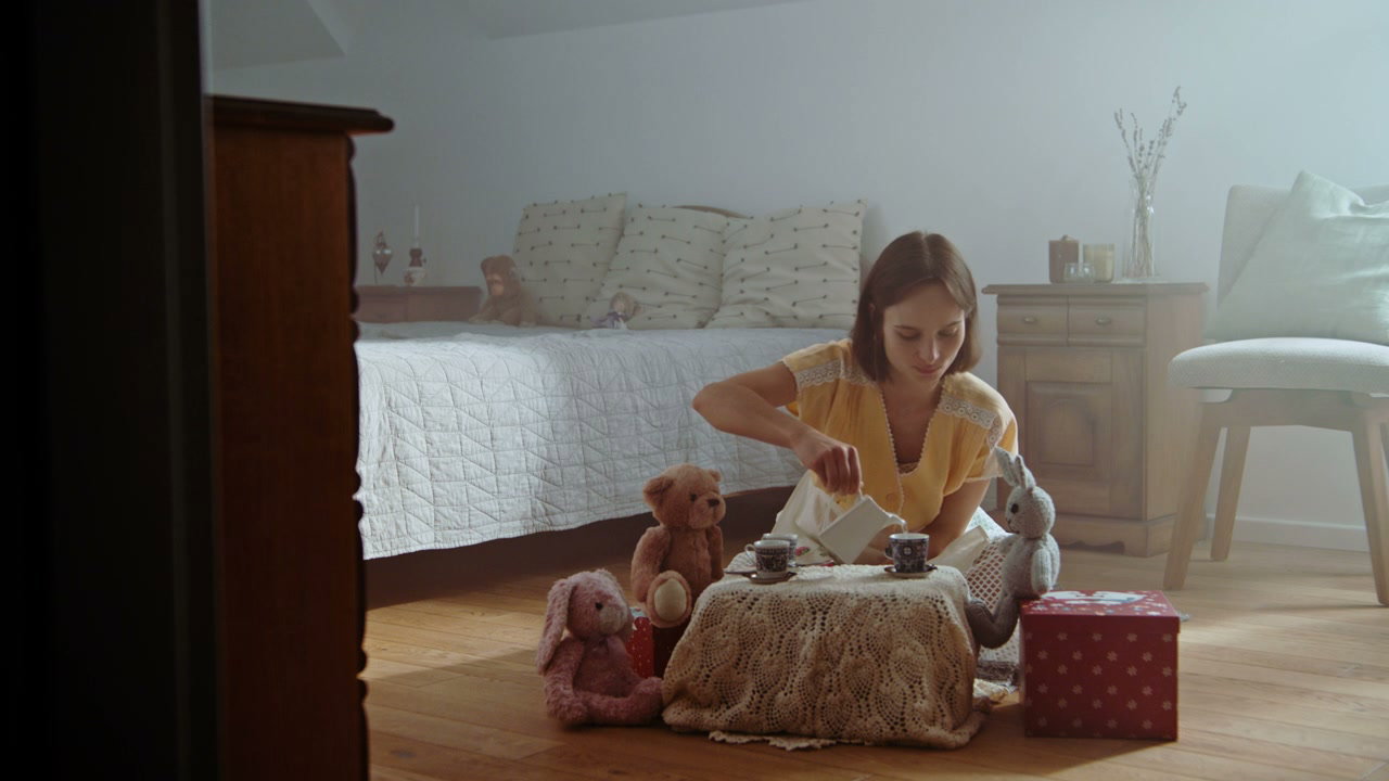 Woman Playing Tea Party with Stuffed Animals