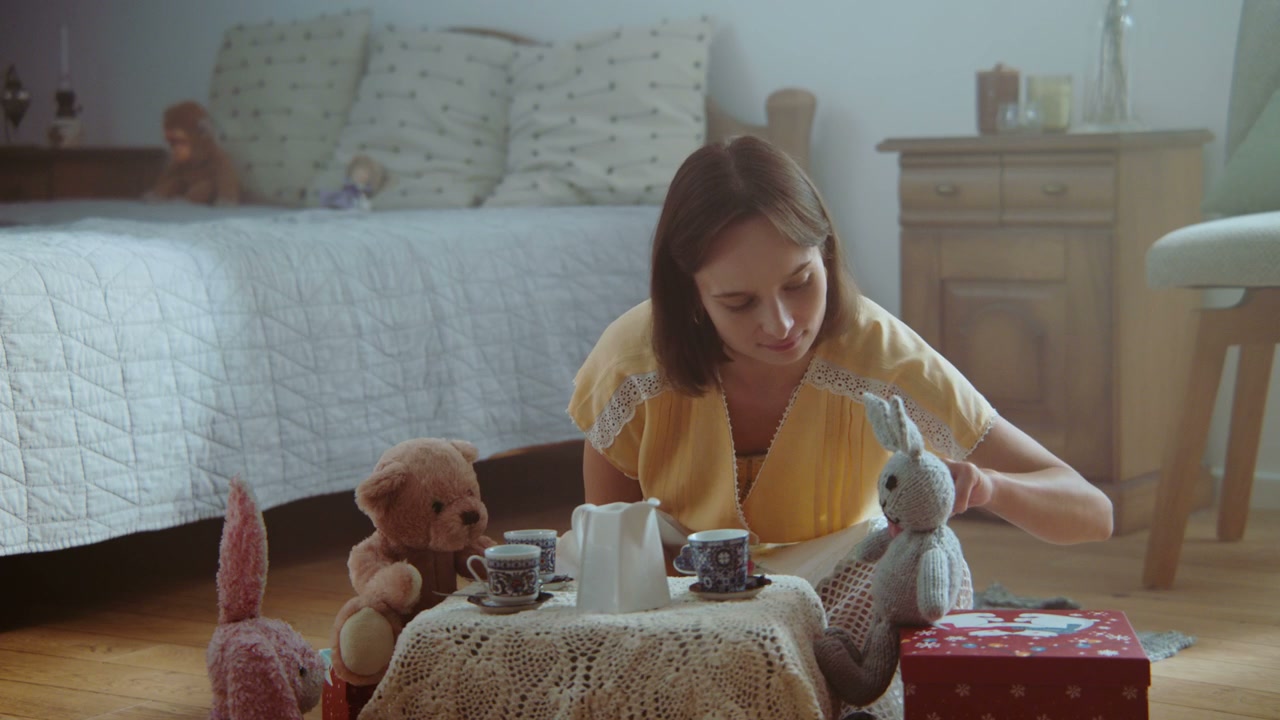 Woman Playing Tea Party with Stuffed Animals