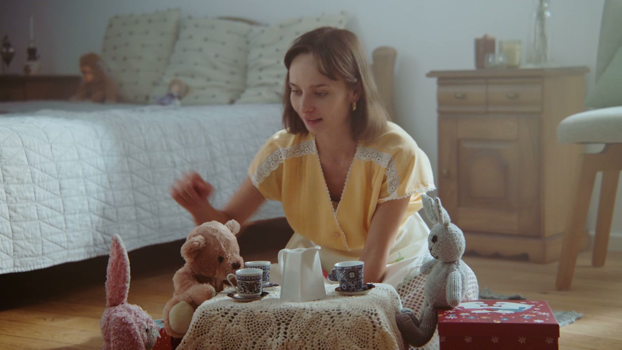 Woman Playing Tea Party With Stuffed Animals