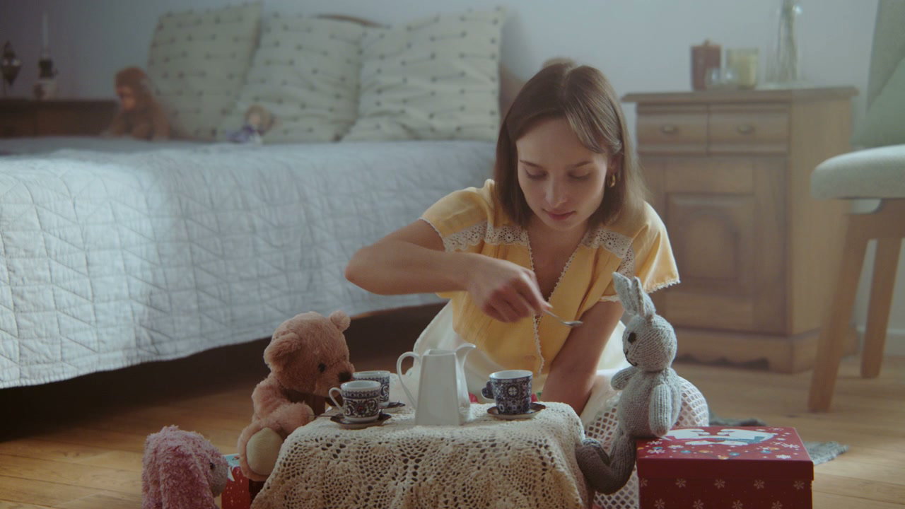 Woman Playing Tea Party with Toys
