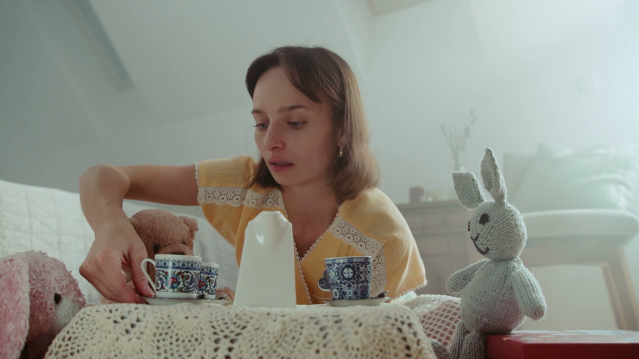 Woman Hosting Tea Party with Plush Toys
