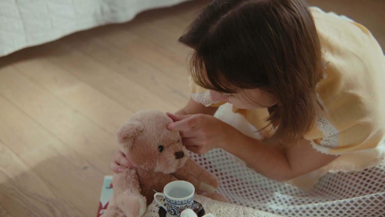 Girl Playing Tea Party with Teddy Bear