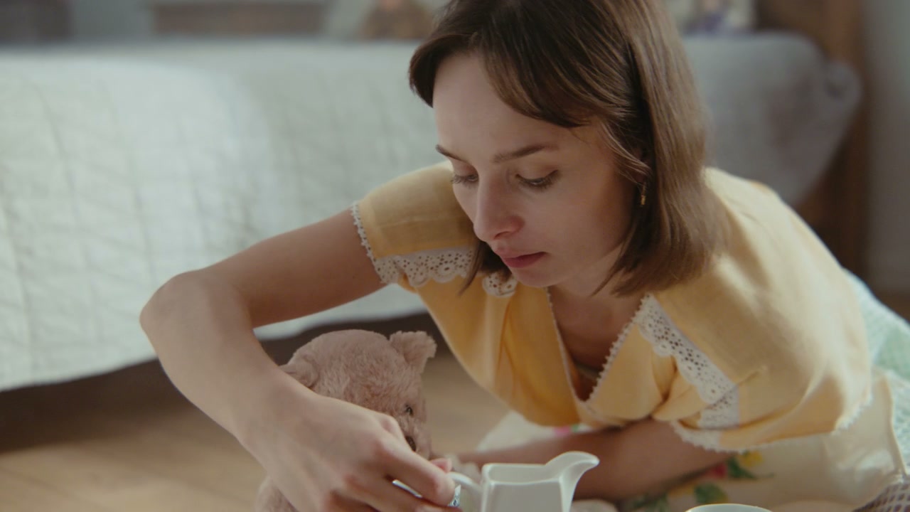 Woman Playing Tea Party With Teddy Bear