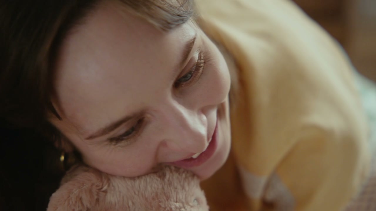 Smiling Woman Cuddling Teddy Bear