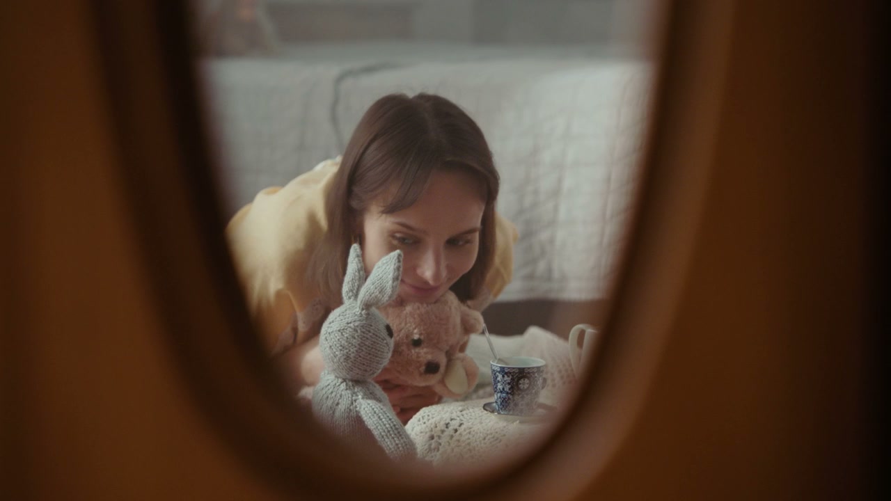 Woman Playing Tea Party with Stuffed Animals
