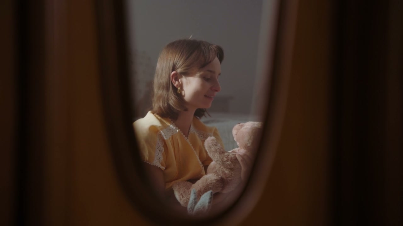 Young Woman Embracing Teddy Bear in Mirror