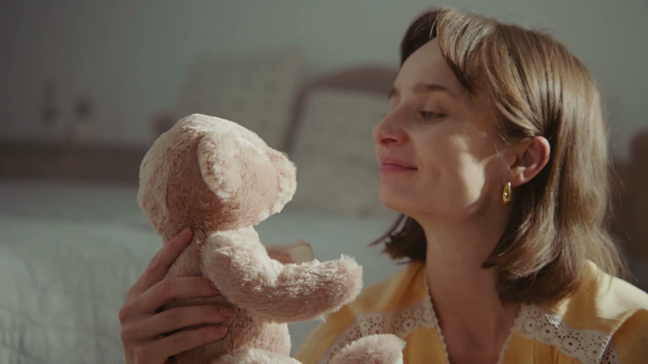 Woman Kisses Teddy Bear