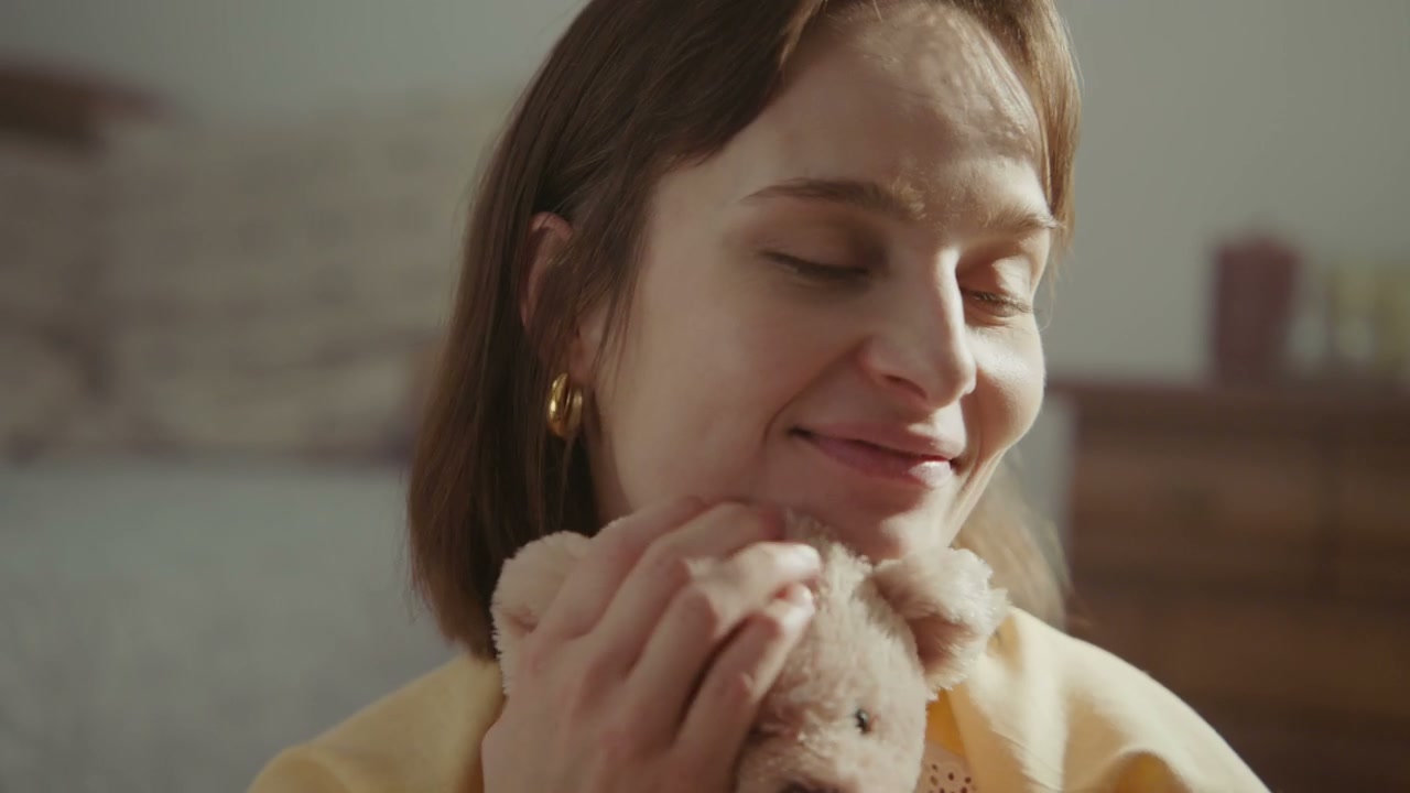 Young Woman Playing with Teddy Bear