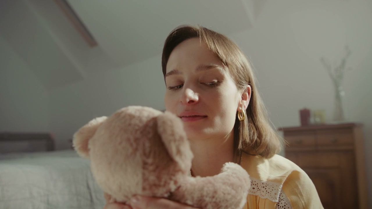 Woman Cuddling a Teddy Bear