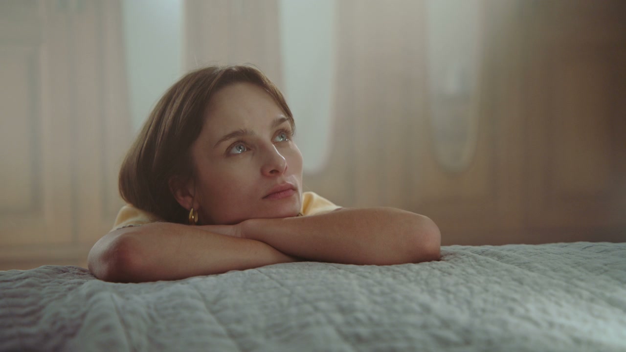 Thoughtful Woman Resting on Bed