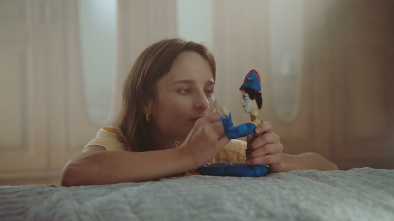 Young Woman Playing with Toy Doll