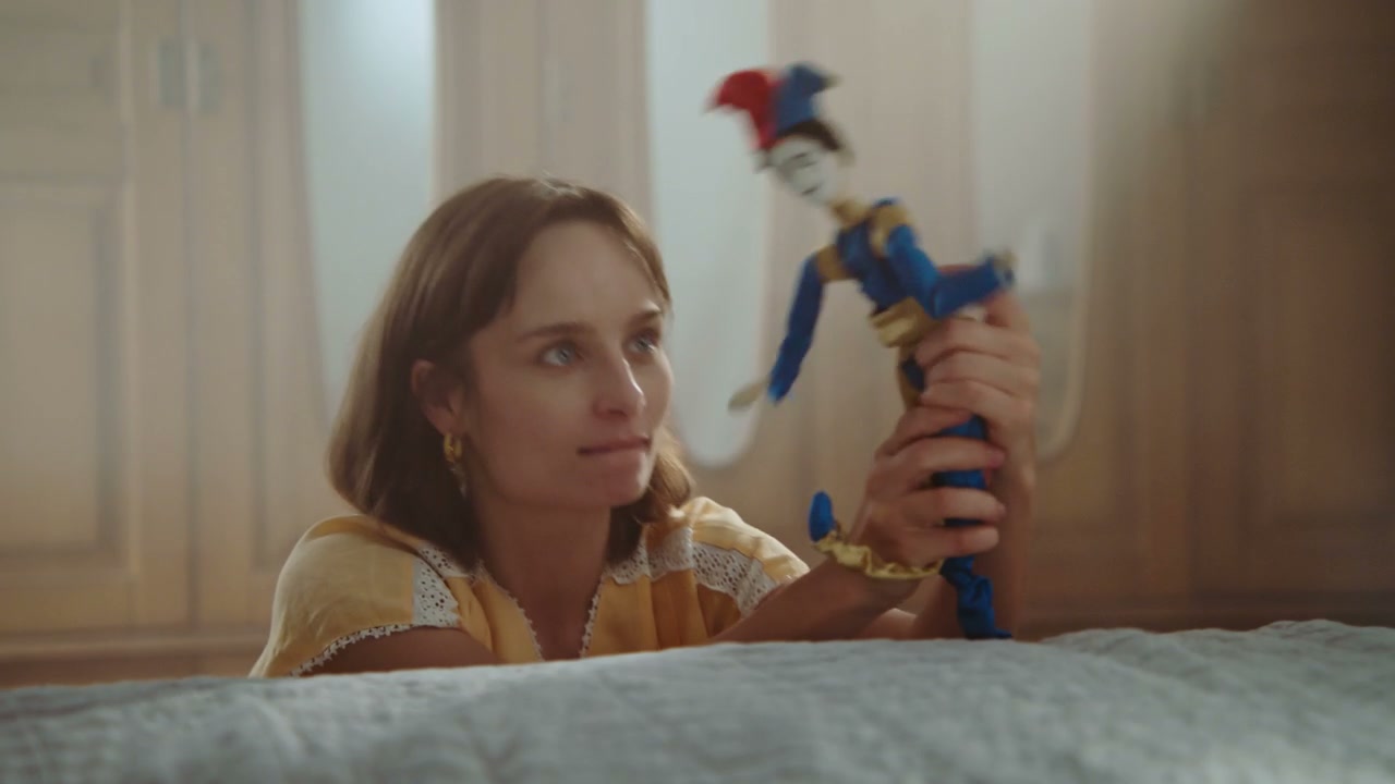 Woman Playing with Jester Puppet