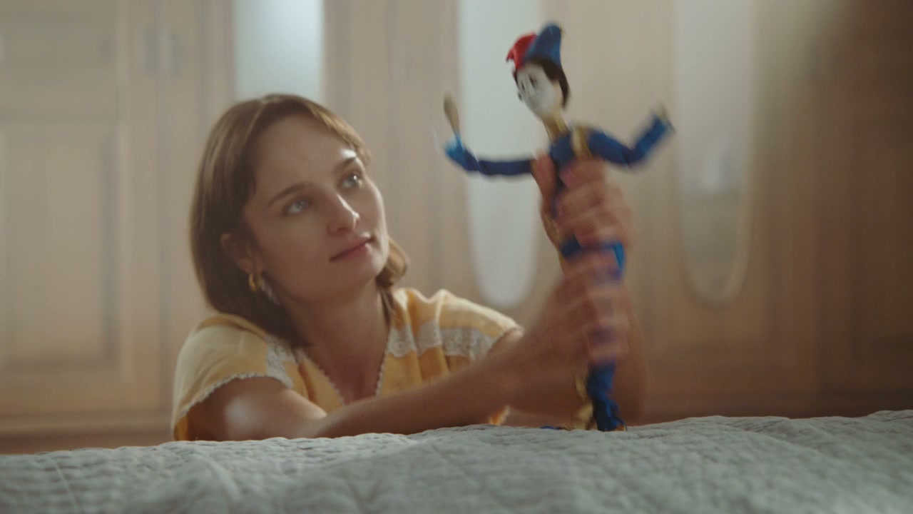 Young Woman Playing with Jester Puppet