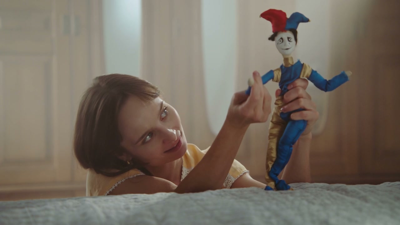 Woman Playing with Jester Doll