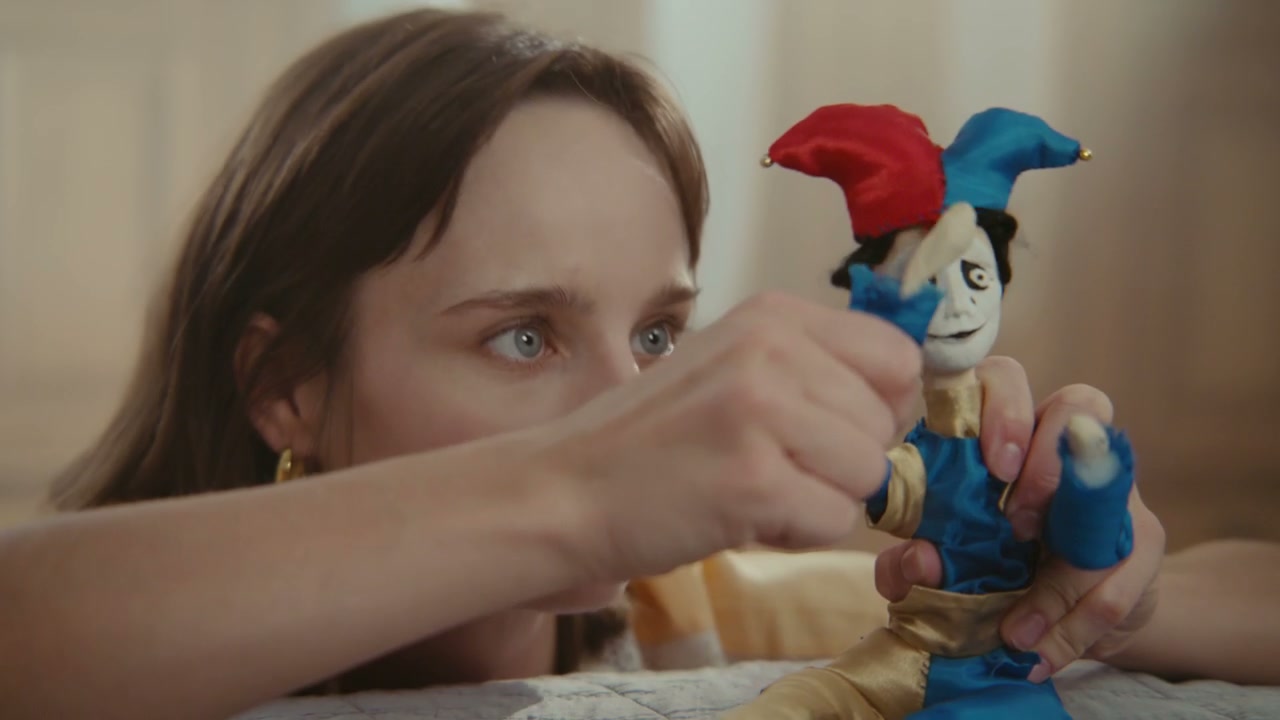 Woman Playing with Jester Puppet
