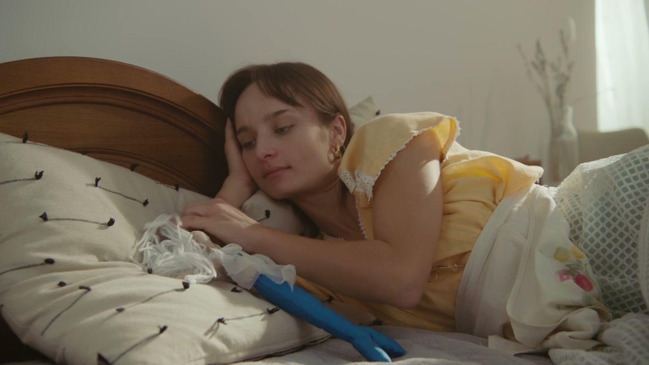 Woman Falling Asleep in Bed with Doll