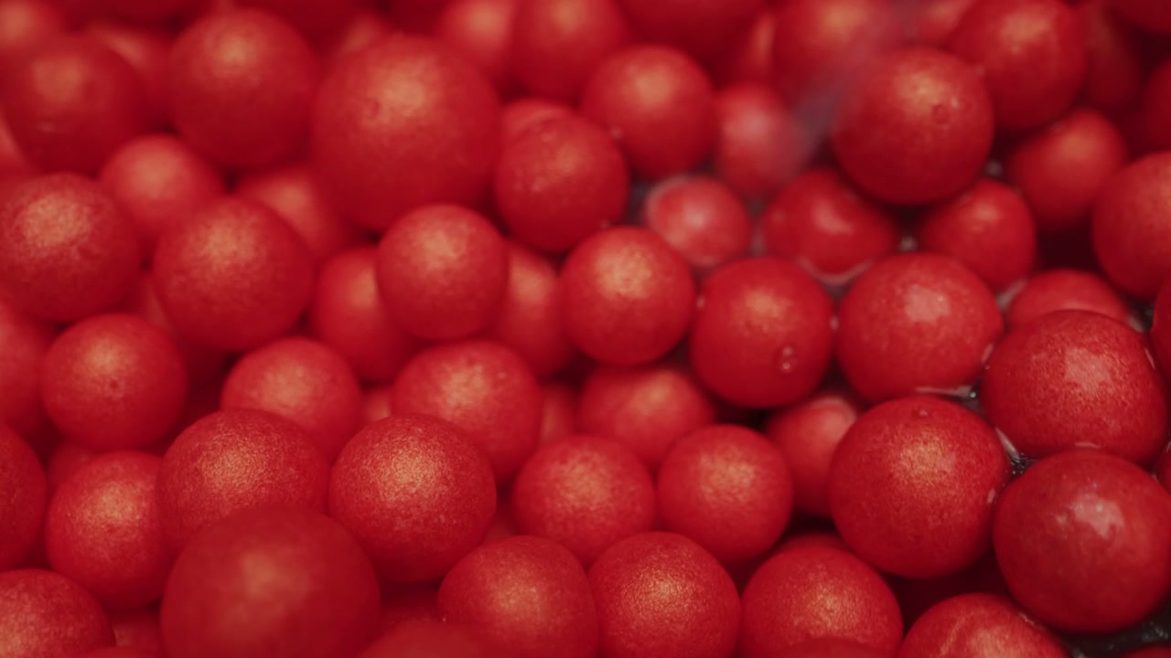 Small Red Orbs Swirling in Liquid